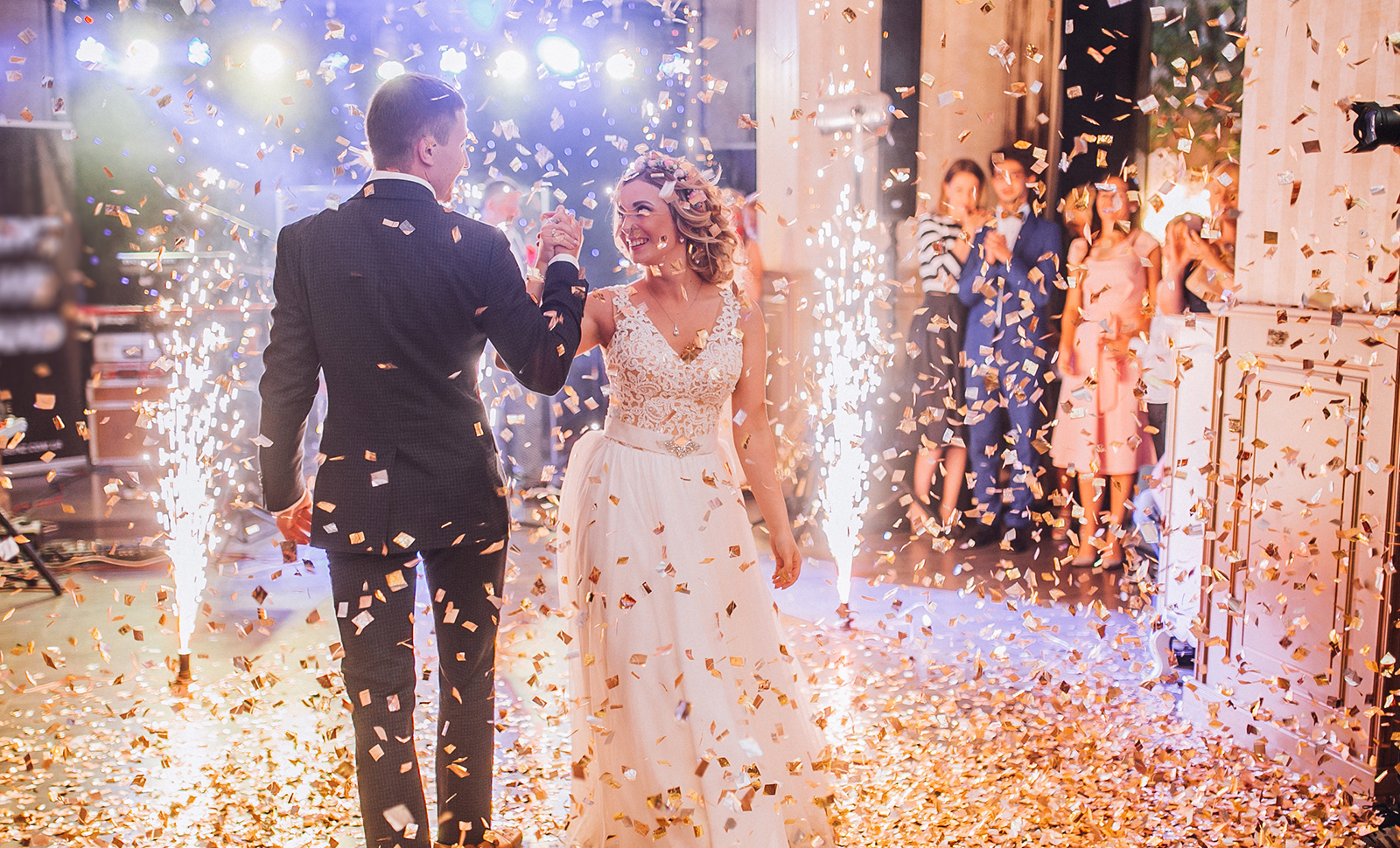 bride and groom celebrating on dancefloor with confetti